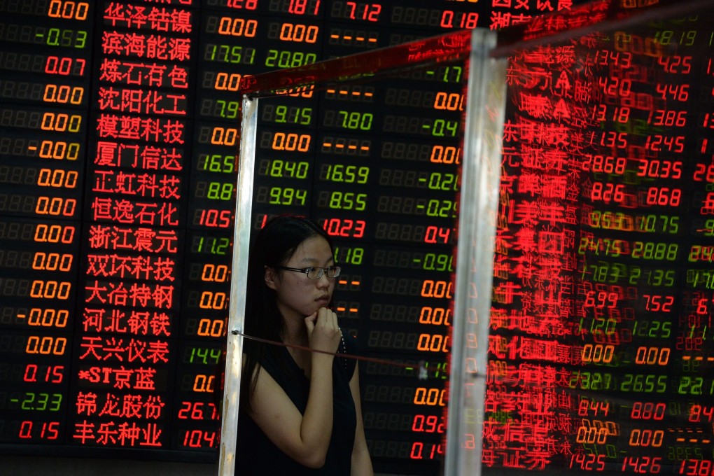 An investor watches stock prices on a screen in China as shares in Shanghai and Shenzhen climbed on Monday. Photo: EPA