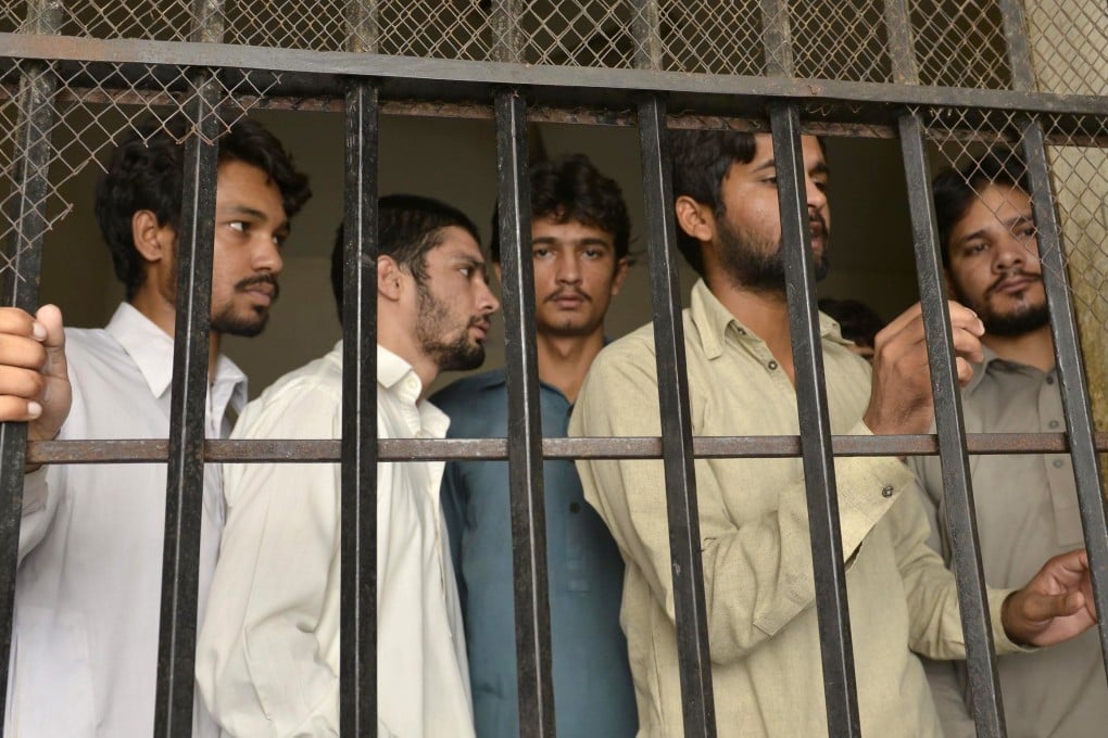 Arrested gang members involved in a sexual abuse scandal are held in a police lockup in Hussain Khanwala village. Photo: AFP