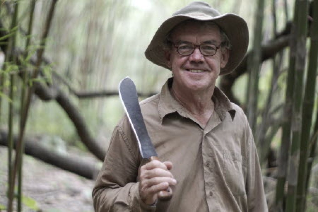Rod Beattie poses with a machete along the path of what was the Death Railway in Nam Tok, Kanchanaburi province, Thailand. Photo: AP