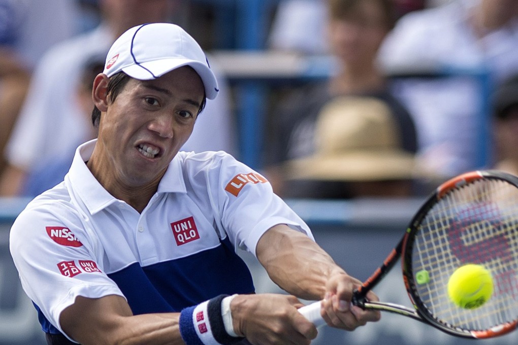 Kei Nishikori returns the ball to John Isner. Photo: EPA