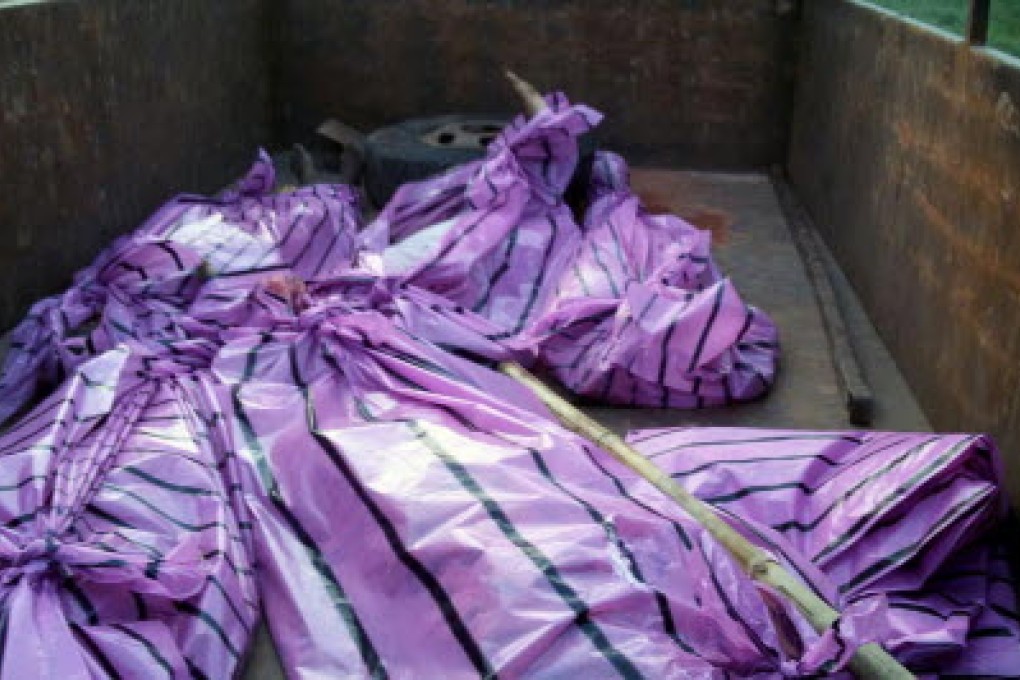 The bodies of five women killed by villagers who accused them of practicing witchcraft lay in plastic bags in Kanjia village. Photo: AFP