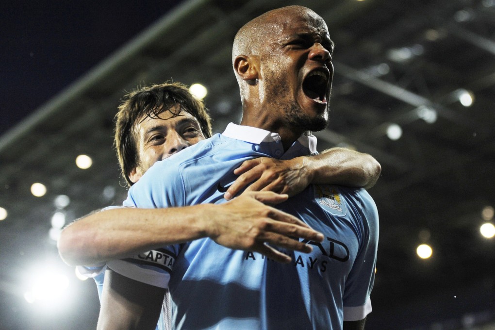 Manchester City captain Vincent Kompany, right, celebrates after netting during his team's opening victory of the season. Photo: EPA