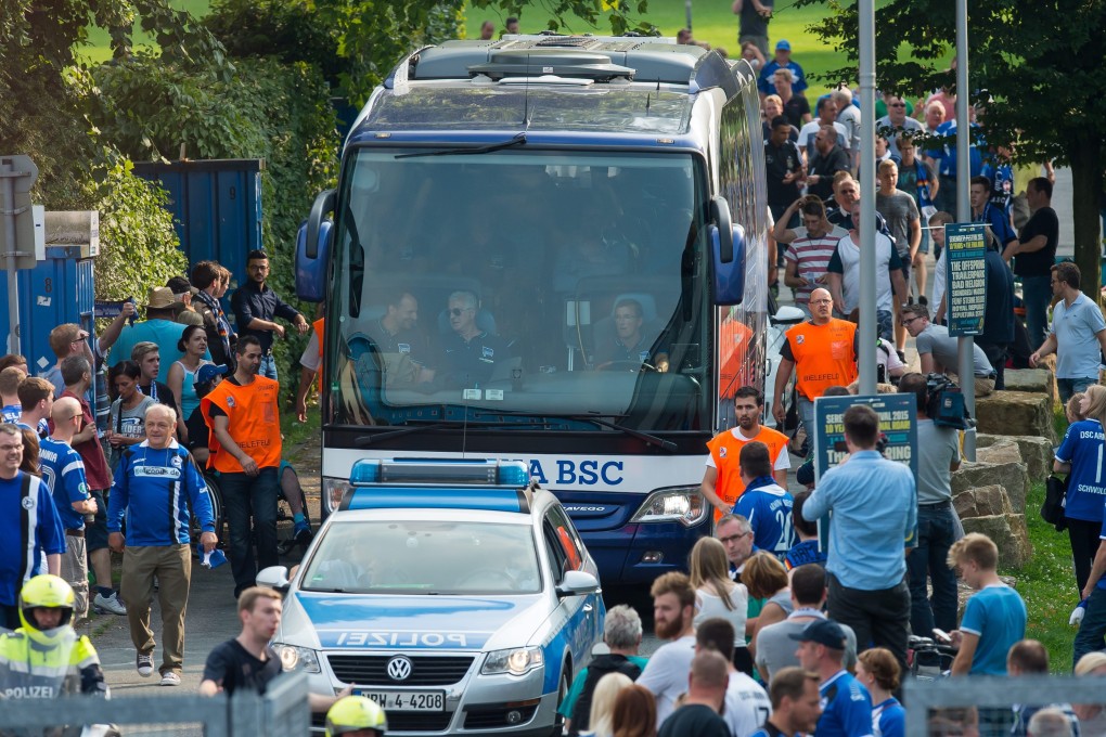 The team bus of Hertha Berlin is escorted by police as it arrives at the Schueco Arena prior to the German Cup match against Arminia Bielefeld. Photo: EPA