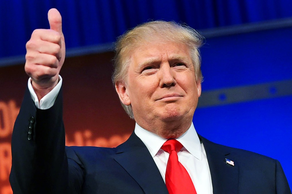 Real estate tycoon Donald Trump flashes the thumbs-up as he arrives on stage for the start of the prime time Republican presidential debate on August 6, 2015 at the Quicken Loans Arena in Cleveland, Ohio. Photo: AFP