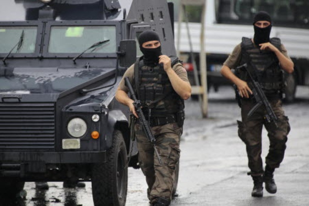 Two members of the police special forces patrol outside a police station after an attack in Istanbul. Photo: Reuters