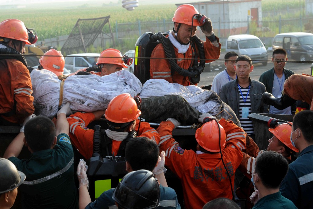 Rescuers carry a miner to safety after a deadly flood at a mine in Heilongjiang province in July. File photo: Xinhua