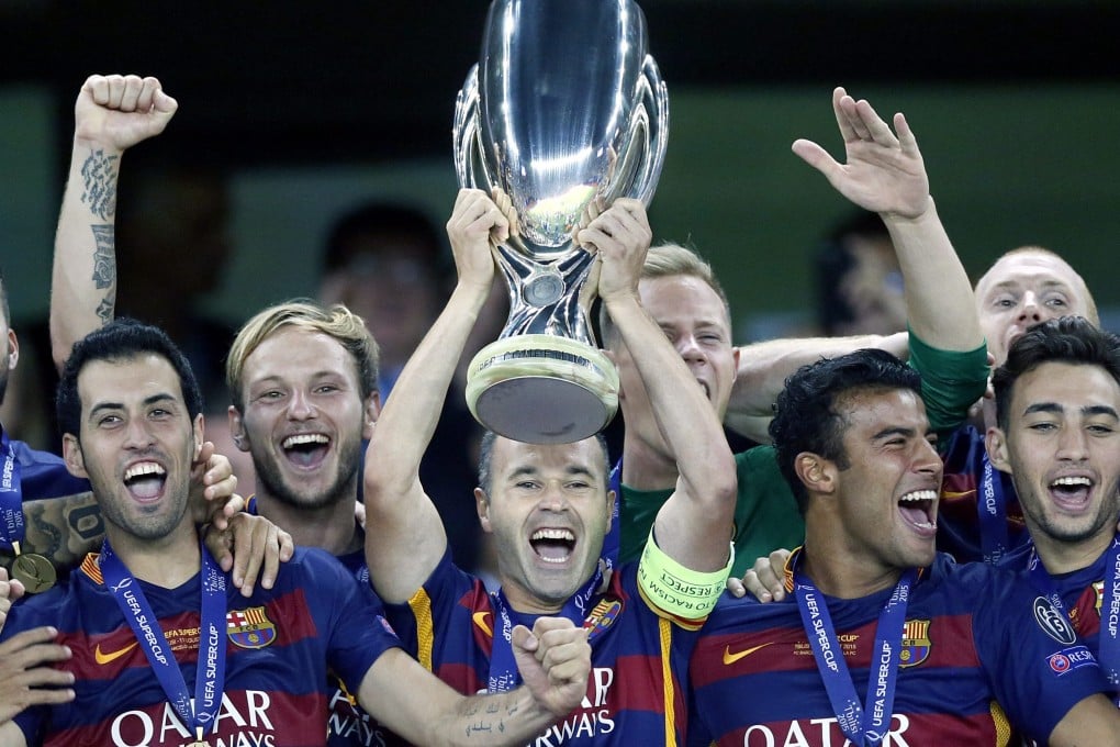 Barcelona captain Andres Iniesta (center) celebrates with the trophy after winning the Uefa Super Cup against Sevilla in Tbilisi, Georgia. Photo: EPA