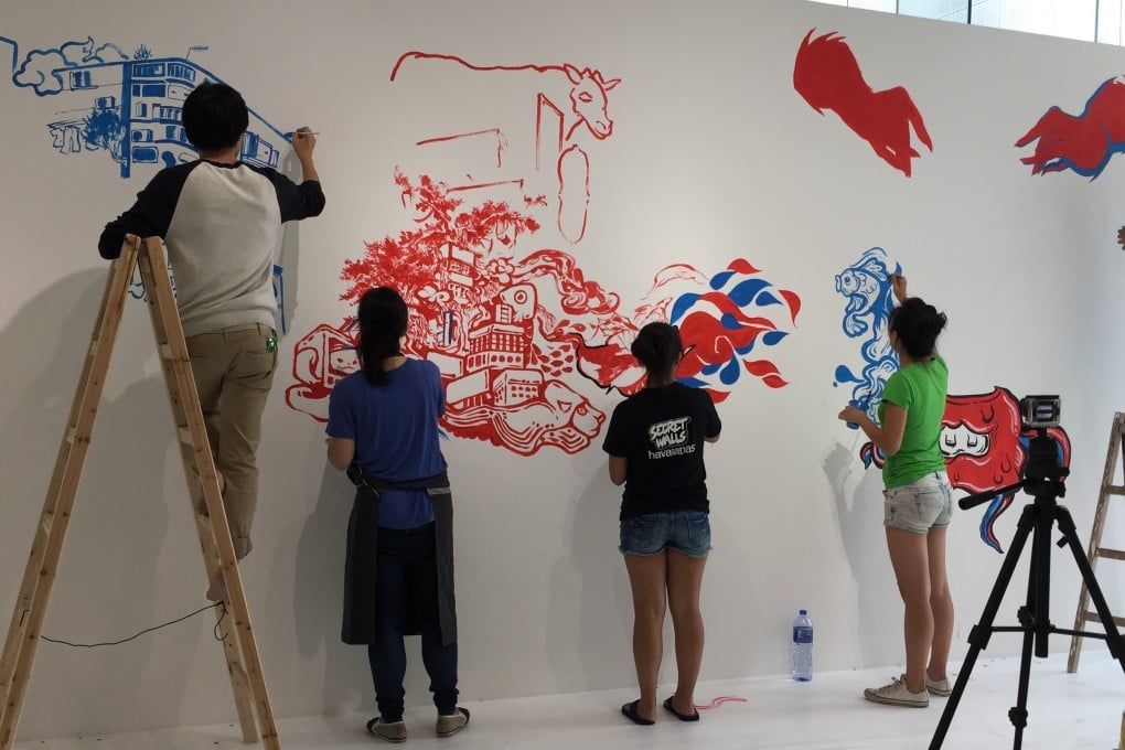 Street artists at work at the Sheung Wan gallery. Members of the public can watch the artists at work and talk to them about the project.