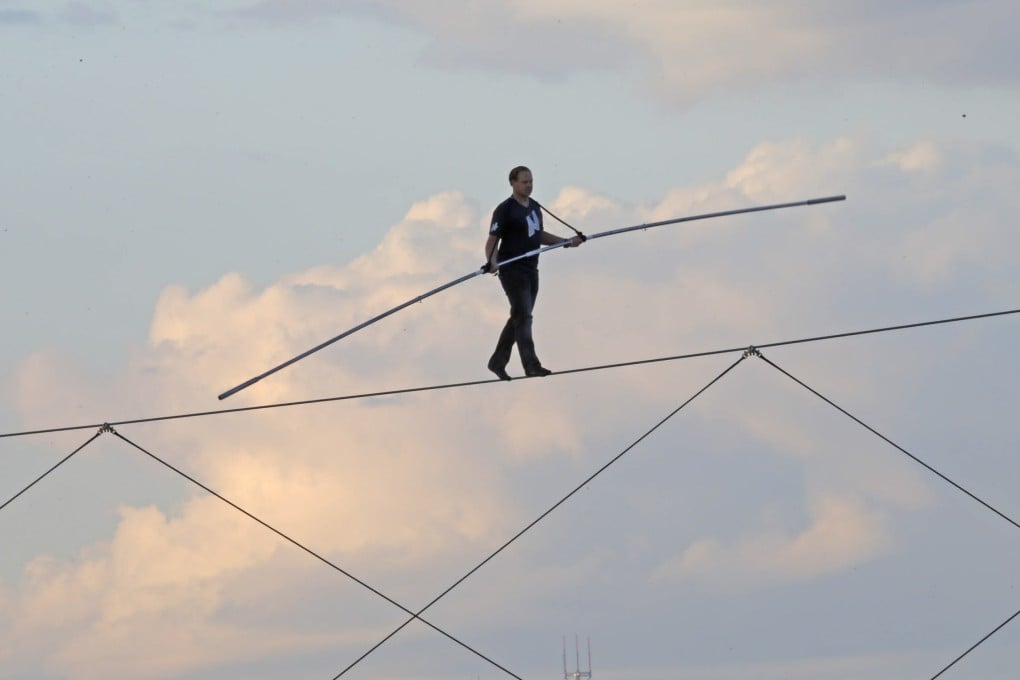 High-wire daredevil Nik Wallenda walks a tightrope above the Milwaukee Mile Speedway. Photo: Milwaukee Journal-Sentinel/AP