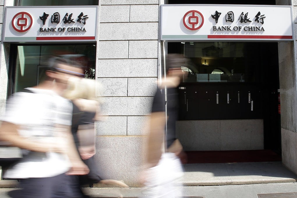 People walk past a branch of the Bank of China in Milan. The bank's overseas expansion plans have been noted favourably by Moody's. Photo: AP