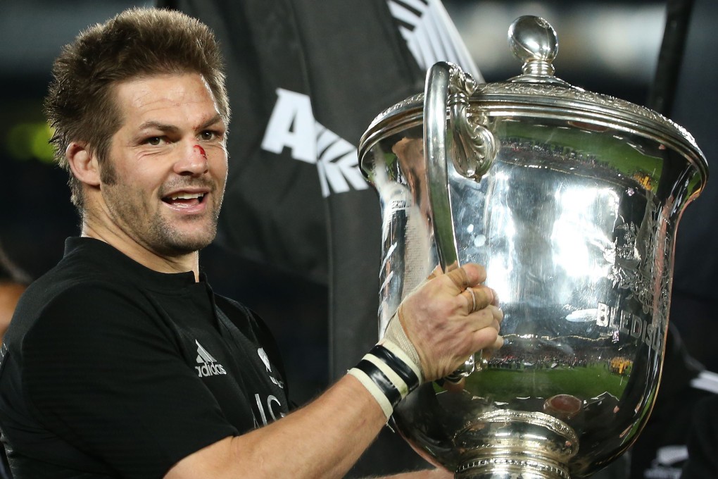 Richie McCaw holds aloft the Bledisloe Cup after the All Blacks defeat Australia 41-13 at Eden Park. Photos: AFP