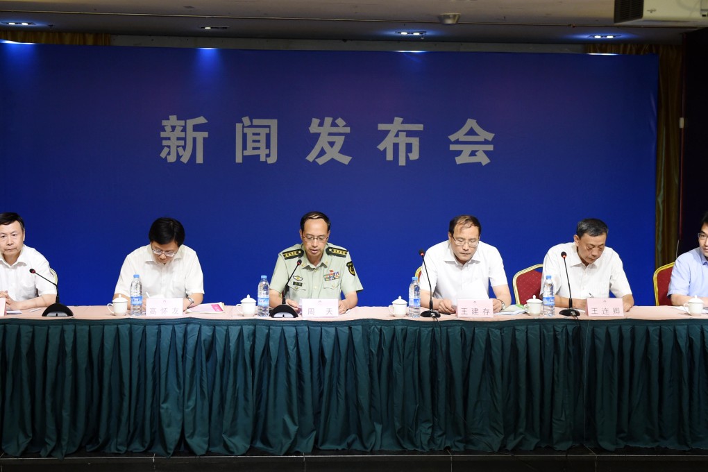 Tianjin's fire department head Zhou Tian (3rd L) speaks during yesterday's press conference on the explosion. The air and water quality in the blasts area in north China's Tianjin is being closely monitored, as on-site conditions are still unclear. Photo: Xinhua