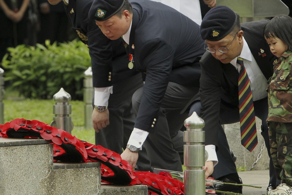 Members of the Royal Hong Kong Regiment place flowers during the commemoration of Victory Day of the 70th Anniversary of liberation of Hong Kong. Photo: Franke Tsang