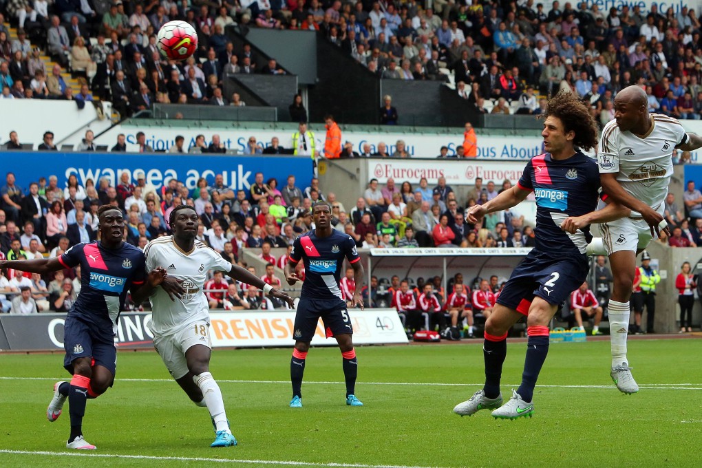 Swansea striker Andre Ayew (right) scores a header past Newcastle in the 2-0 win. Photo: AFP