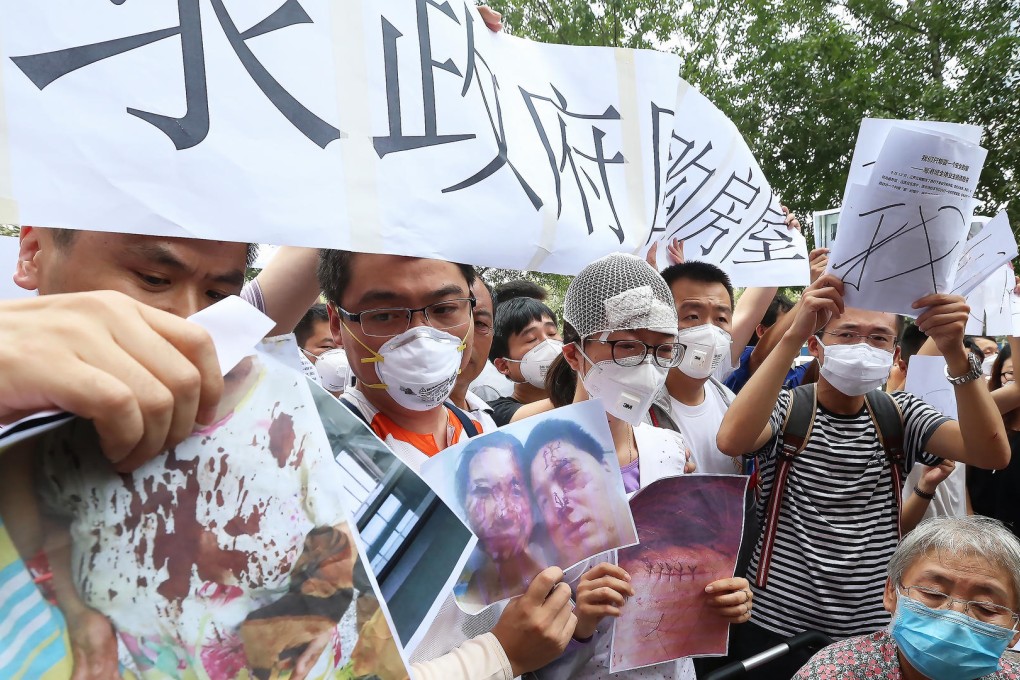 Residents whose homes were damaged in the blasts protest outside the hotel where the authorities hold a daily press conference on the relief efforts. Photo: K.Y. Cheng