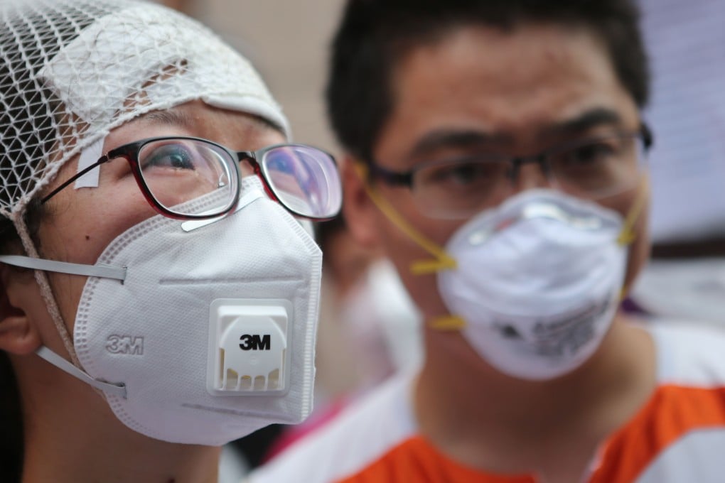 People injured in the Tianjin explosions protest on Monday outside a hotel where the authorities held a press conference. Photo: AFP