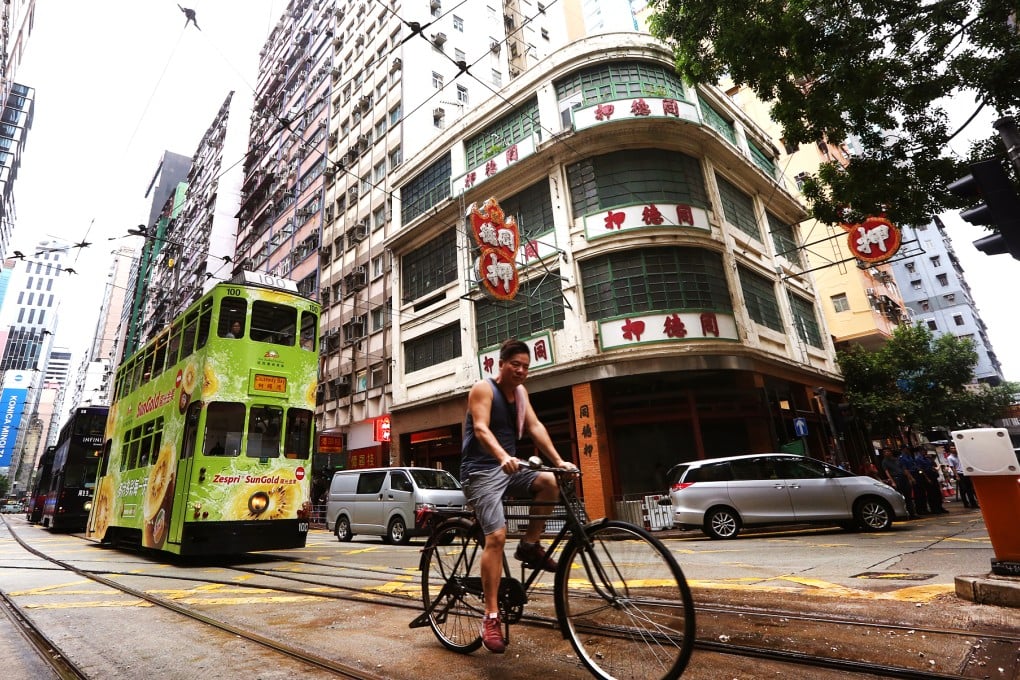 The building is known for its representative verandah and neon signs written from right to left. Photo: Nora Tam