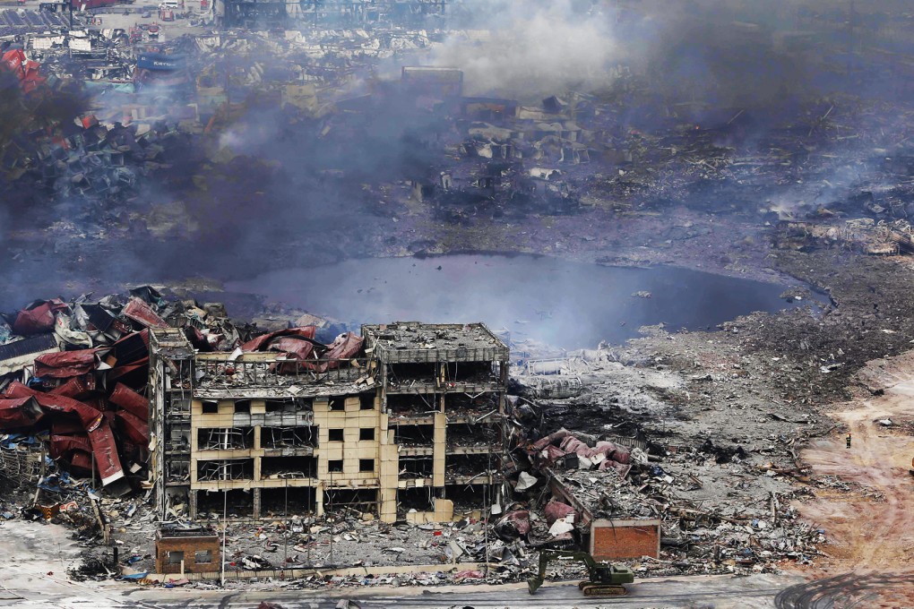 Smoke rises at the site of the warehouse explosions in Tianjin on Friday. Photo: AFP