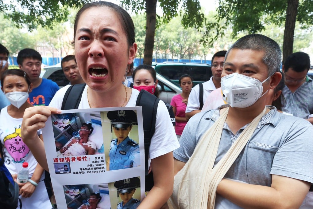 Family members of the contract firefighters who perished, are missing or were injured in massive warehouse explosions, demonstrate in Tianjin. Photo: K. Y. Cheng