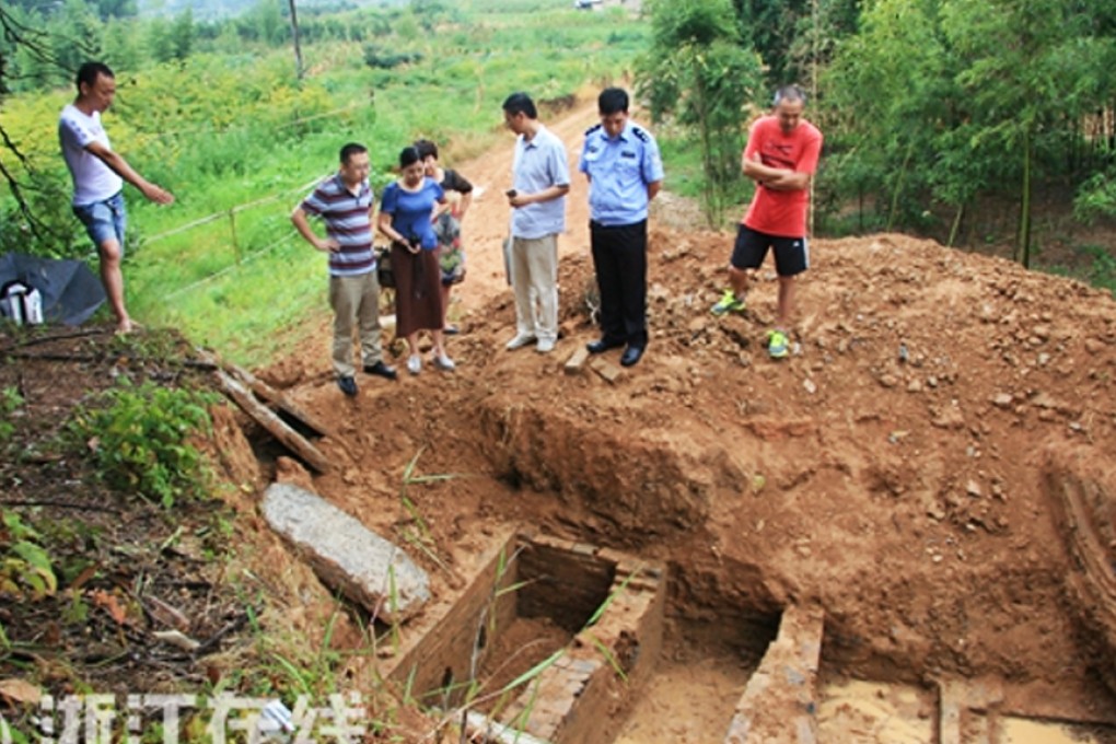 Chinese villagers stand at the site of the illegal excavation at a Song dynasty burial tomb in Zhejiang province. Photo: Zjol.com.cn