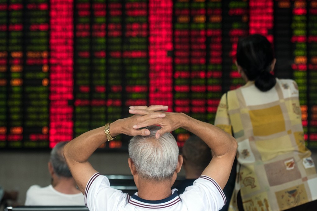 An investor watches anxiously the movement of share prices in Shanghai, China. Photo: AFP