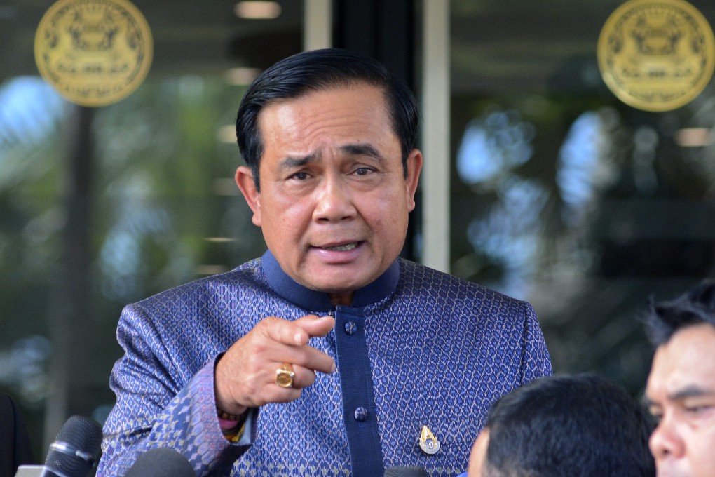 Thai Prime Minister Prayuth Chan-ocha gestures as he speaks to journalists a day after the bomb attack. He said police were hunting a male suspect. Photo: EPA
