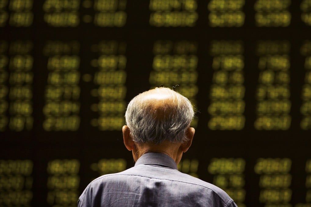 A Chinese investor gestures while watching volatile stock prices in Shanghai. Photo: AP