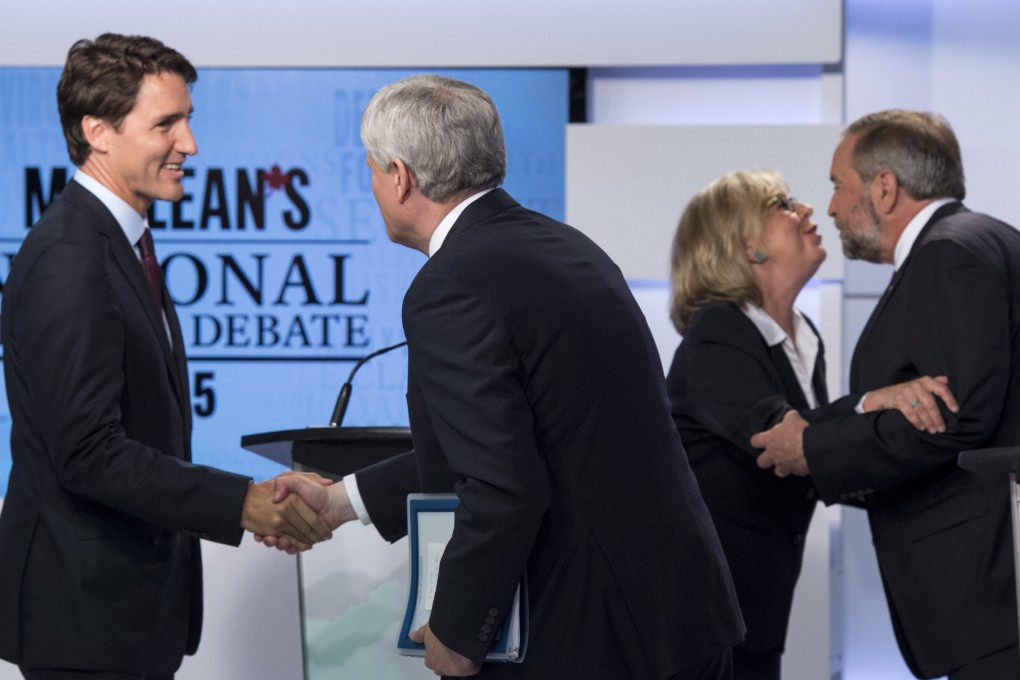 Leader of Canada's Liberal Party Justin Trudeau (left) shakes hands with Conservative leader Stephen Harper as Green party leader Elizabeth May and New Democrat leader Thomas Mulcair embrace following an election debate earlier this month. Nearly 200,000 Hong Kong Canadians have been deprived of a vote in the election. Photo: Frank Gunn/The Canadian Press via AP