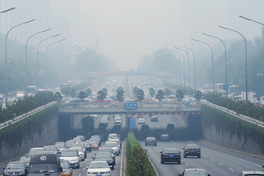 Vehicles runs in smog covered streets in Beijing. China's cities are often hit by heavy pollution as the battle to fight climate change and global warming suffers from under-investment in research and development. Photo: AFP