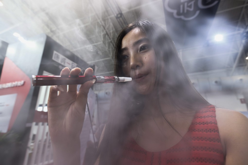 A model puffs on an e-cigarette at a vaping expo in Bejing last month. Photo: EPA