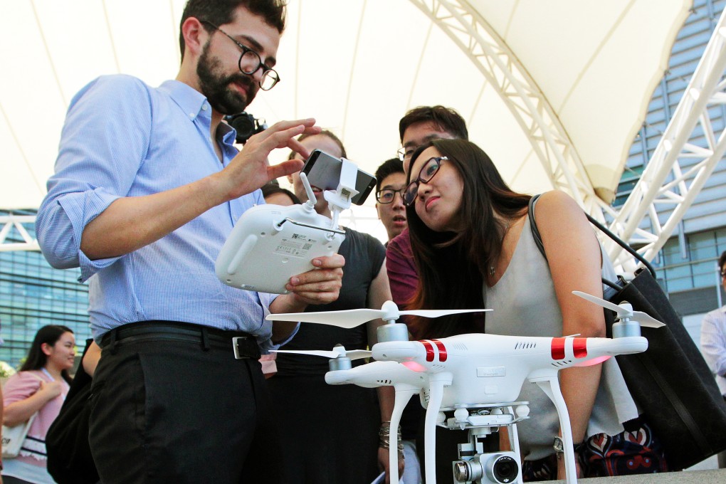 Michael Perry, director of communications at drone maker DJI, demonstrates the new Phantom 3 at Hong Kong Science and Technology Park on Tuesday. Photo: Bruce Yan