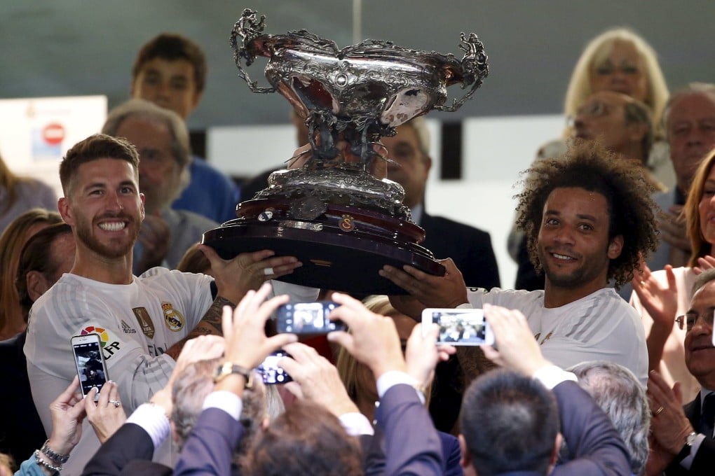 Real Madrid's Sergio Ramos (left) and Marcelo hold the Santiago Bernabeu Trophy aloft after their win against Galatasaray. Photo: Reuters