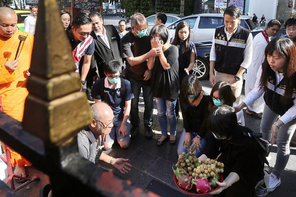 Relatives of Hong Kong victims of the bombing say a prayer outside the Erawan Shrine, scene of the blast, yesterday. Photo: Sam Tsang