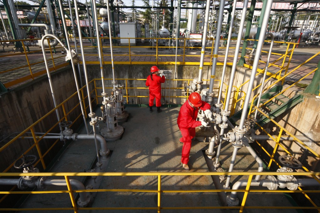 Workers work on gas pipelines in China as ENN Energy revised down its gas sales volume growth. Photo: AFP