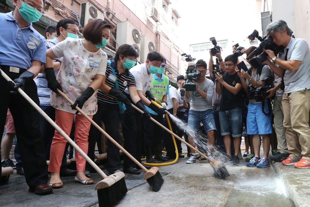 Secretary for Food and Health Ko Wing-man (fourth from left) cleans a Wan Chai street as part of the campaign. Photo: Felix Wong
