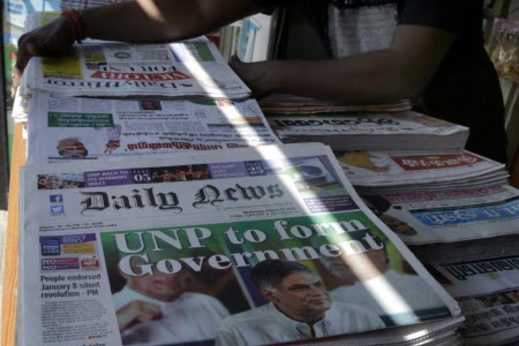 A vendor sells newspapers reporting on parliamentary elections results, in Colombo, Sri Lanka, on August 19. Photo: EPA