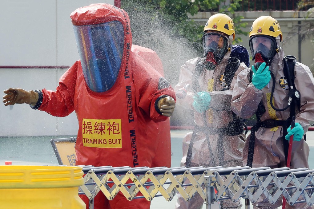 Hazmat team members in Sha Tin yesterday demonstrate how hazardous material incidents are handled.Photo: Edward Wong