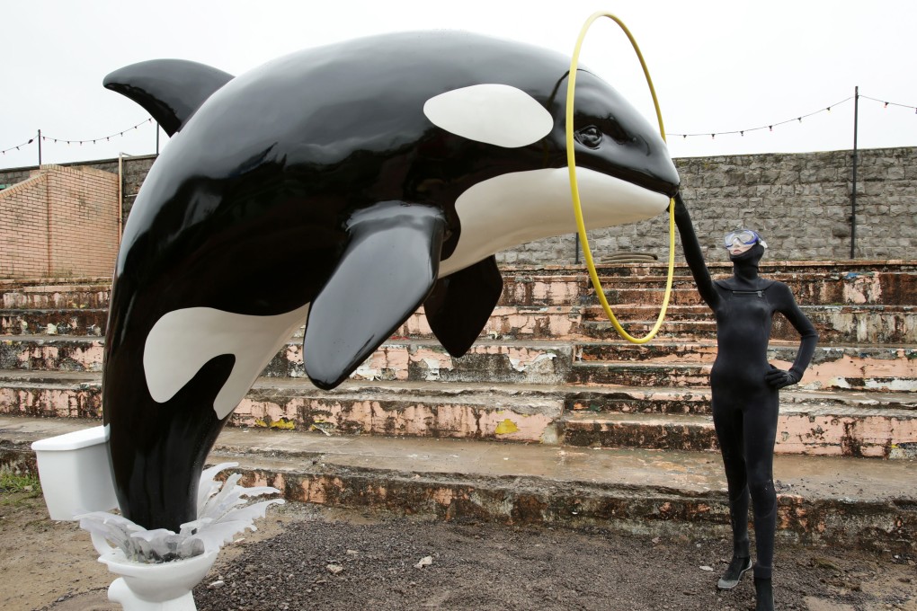 A Banksy piece depicting an orca whale jumping out of a toilet. Photo: AP