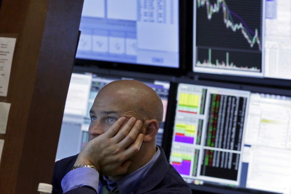 A Wall Street trader stares glumly at his screen as stocks were pounded on fears of weak growth in China as equities there stumbled on Thursday. Photo: AP