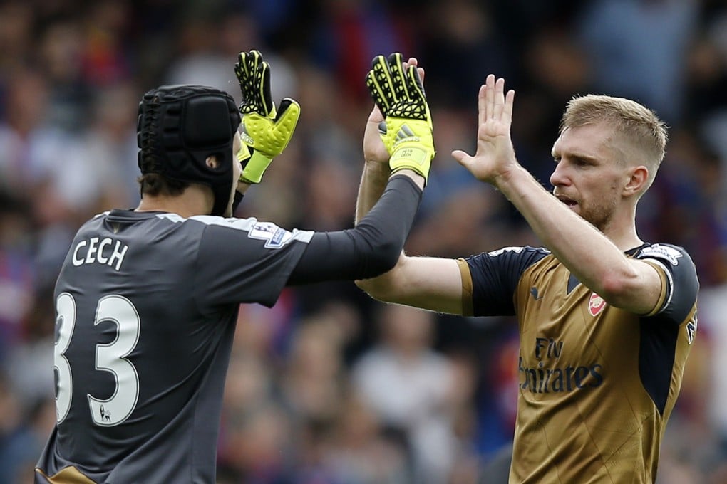 Arsenal goalkeeper Petr Cech (left) and defender Per Mertesacker celebrate their win over Crystal Palace last week. The Gunners face a tougher test against Liverpool. Photo: AFP