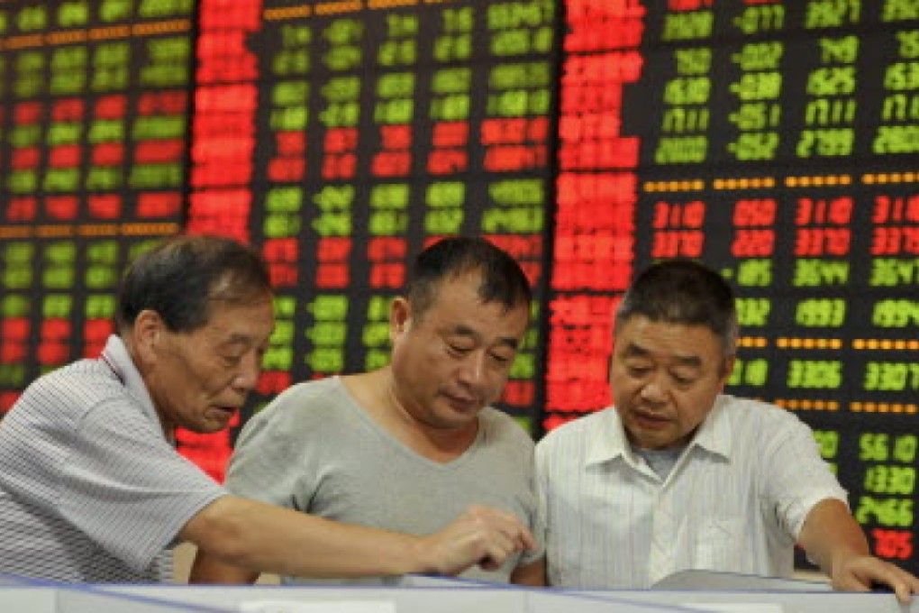 Investors in Fuyang, Anhui province, check how their stocks fared on Friday. Photo: Reuters
