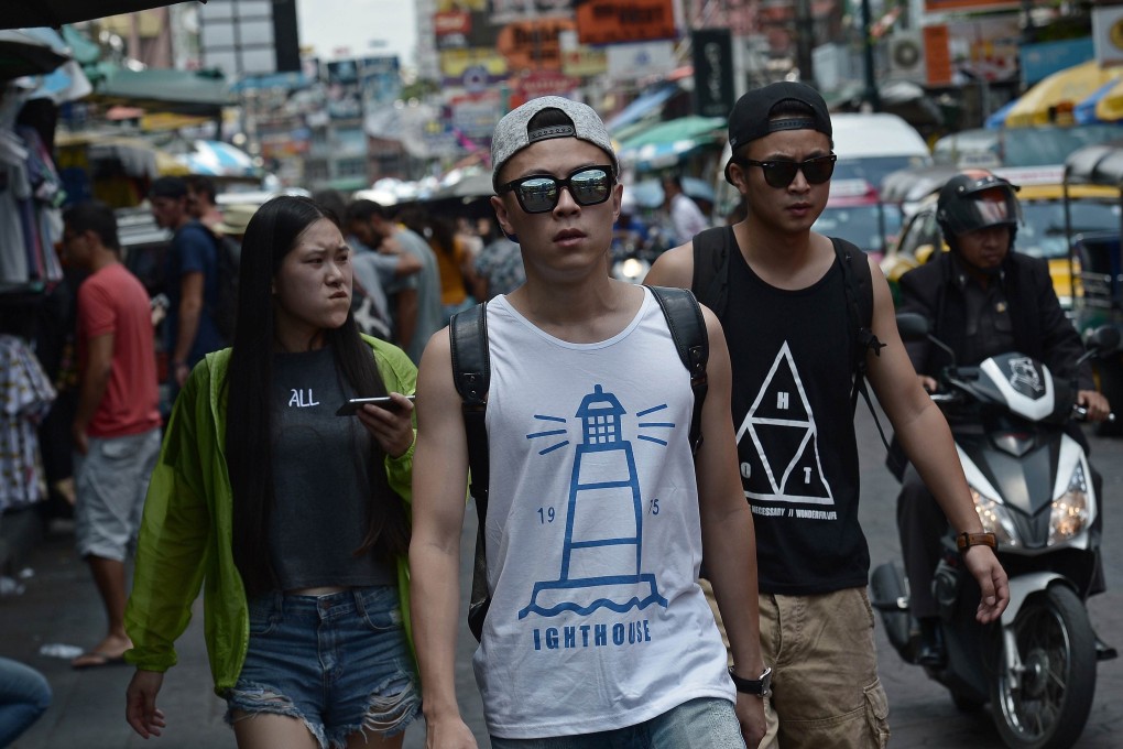 Chinese tourists walk along Khao San road, popular with many foreign visitors, in Bangkok, days after a bomb attack rocked the Thai capital. Photo: AFP