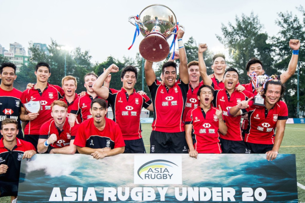 Skipper Richard Lewis hoists the silverware as Hong Kong celebrate winning their second successive Asia Rugby U20 Sevens Series title on Saturday at King's Park. Photos: HKRU
