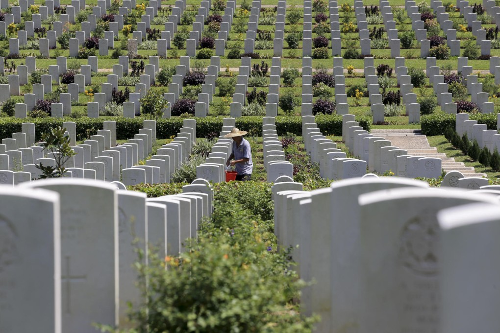 A worker cleans the Sai Wan cemetery ahead of celebrations marking the 70th anniversary of the end of the world war.Photo: Felix Wong