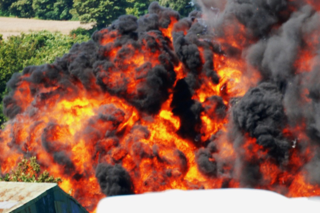 An explosion at the Shoreham Air Show after a fighter jet crashed. The 1950s Hawker Hunter crashed into several cars on a nearby road exploding in a huge fireball. Photo: EPA