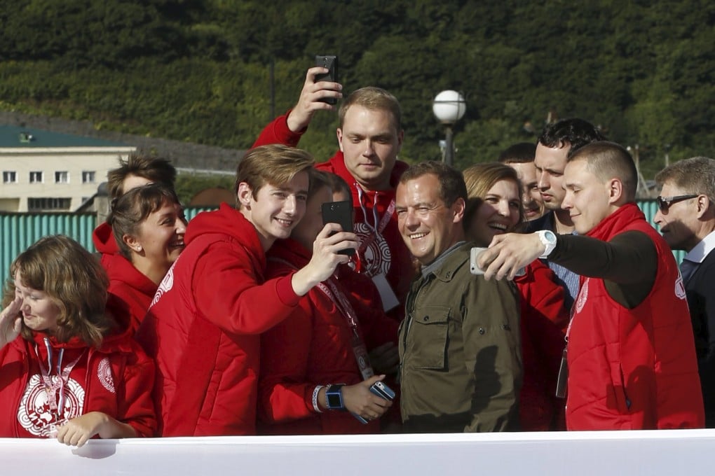Russia's Prime Minister Dmitry Medvedev poses for 'selfies' during his visit to Iturup Island, one of four islands known as the Southern Kurils in Russia and the Northern Territories in Japan. Photo: Reuters