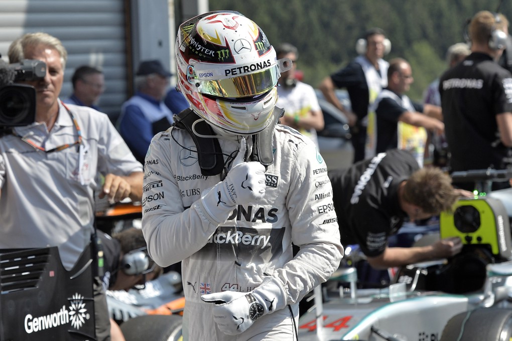 Mercedes driver Lewis Hamilton shows a thumbs up after setting the pole position in qualifying. Photo: AP