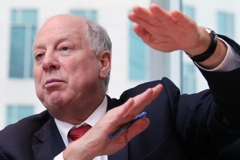 Andrew Michelmore, Chief Executive Officer of MMG Limited, gestures as the company may be looking for another acquisition in the months ahead. Photo: May Tse