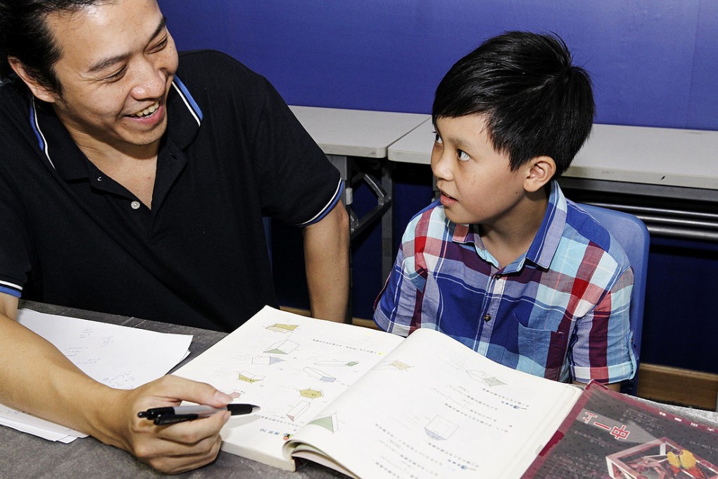 Hong Kong Memory Study Association executive director Lam Kin-tung (left) gives Nathan Lee a lesson. Photo: Franke Tsang