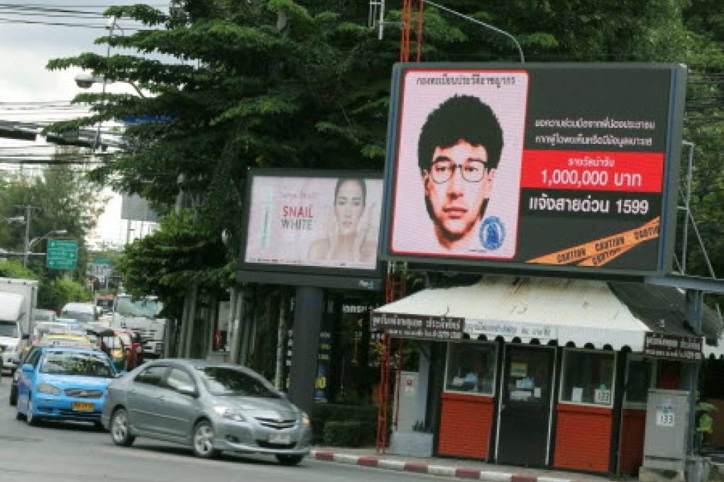The billboard displays 'Thailand's most wanted' with a detailed sketch of a man suspected of planting a bomb near the Erawan Shrine. Photo: EPA
